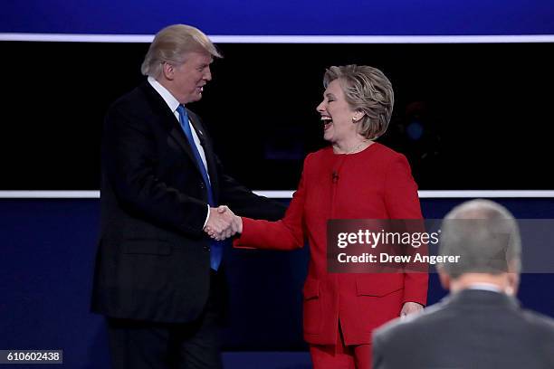 Republican presidential nominee Donald Trump and Democratic presidential nominee Hillary Clinton shake hands after the Presidential Debate at Hofstra...