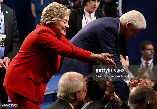 Democratic presidential nominee Hillary Clinton looks on with husband and former U.S. President Bill Clinton after the Presidential Debate with...