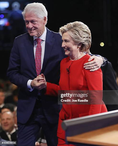 Democratic presidential nominee Hillary Clinton shakes hands with husband and former U.S. President Bill Clinton after the Presidential Debate with...