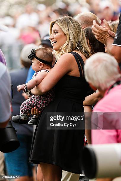 Ellie Day, wife of Jason Day, holds their daughter Lucy on the 18th hole green during Jason's victory in the final round of the Arnold Palmer...