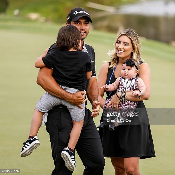 Jason Day of Australia celebrates with his wife Ellie and their kids Dash and Lucy after his victory on the 18th hole green during the final round of...
