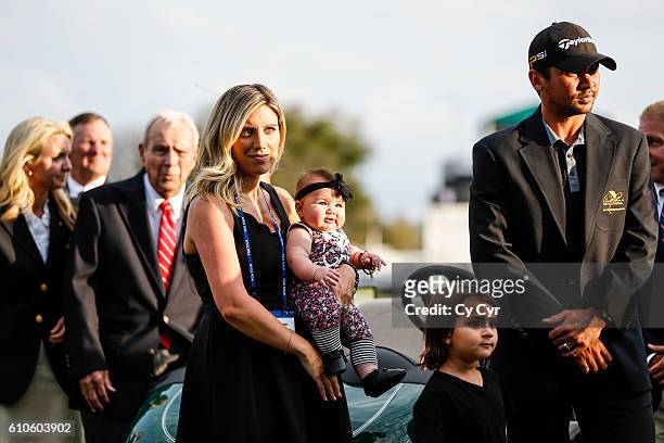 Jason Day of Australia, his wife Ellie, and their kids Lucy and Dash stand during a trophy ceremony following Day's one stroke victory on the 18th...