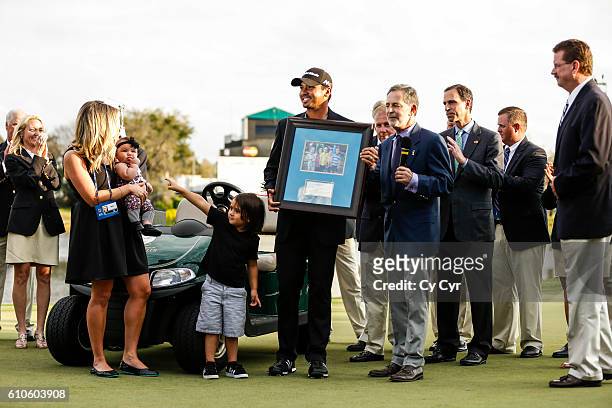 Jason Day of Australia, his wife Ellie, and their kids Lucy and Dash stand during a trophy ceremony following Day's one stroke victory on the 18th...