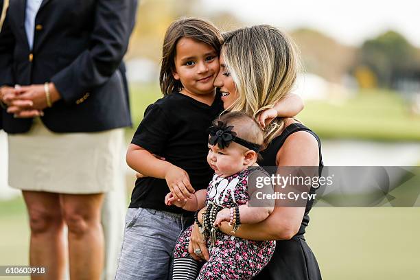 Ellie Day, wife of Jason Day of Australia, and their kids Lucy and Dash attend a trophy ceremony following Day's one stroke victory on the 18th hole...