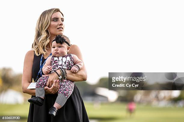 Ellie Day, wife of Jason Day of Australia, holds their daughter Lucy during a trophy ceremony following Day's one stroke victory on the 18th hole...