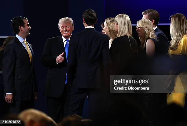 Donald Trump, 2016 Republican presidential nominee, smiles on stage with his family after the first U.S. Presidential debate at Hofstra University in...