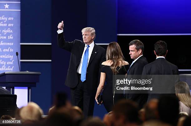 Donald Trump, 2016 Republican presidential nominee, gestures on stage with wife Melania Trump after the first U.S. Presidential debate at Hofstra...