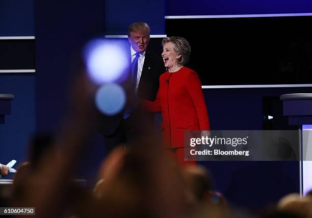 Donald Trump, 2016 Republican presidential nominee, and Hillary Clinton, 2016 Democratic presidential nominee, laugh on stage after the first U.S....