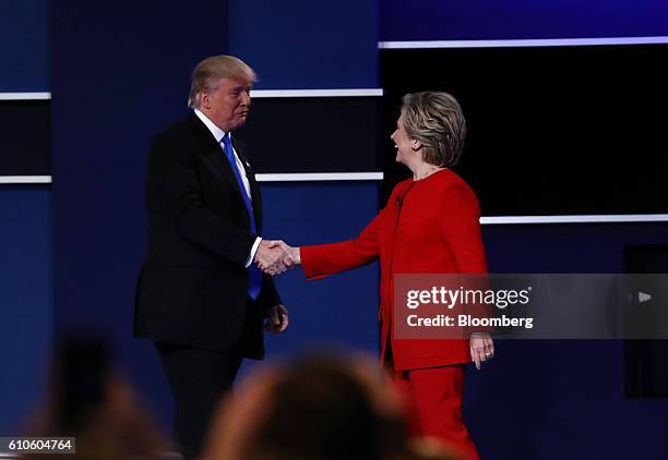 Donald Trump, 2016 Republican presidential nominee, left, shakes hands with Hillary Clinton, 2016 Democratic presidential nominee, after the first...