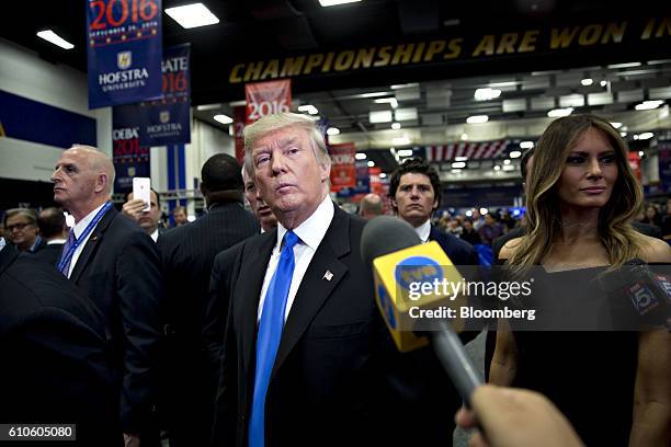 Donald Trump, 2016 Republican presidential nominee, center, speaks to the media following the first U.S. Presidential debate at Hofstra University in...