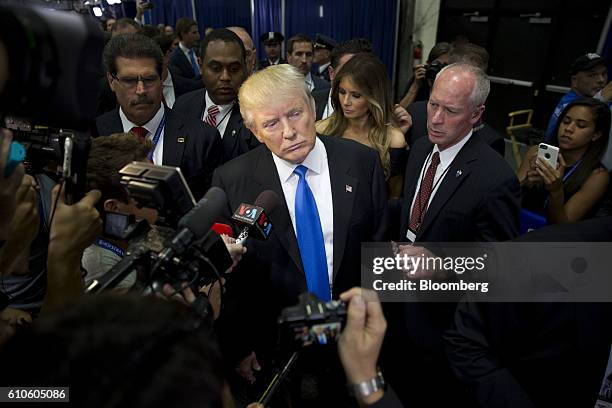 Donald Trump, 2016 Republican presidential nominee, center, speaks to the media following the first U.S. Presidential debate at Hofstra University in...