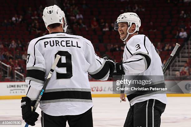 Brayden McNabb and Teddy Purcell of the Los Angeles Kings celebrate after Kyle Clifford scored a third period goal against the Arizona Coyotes during...