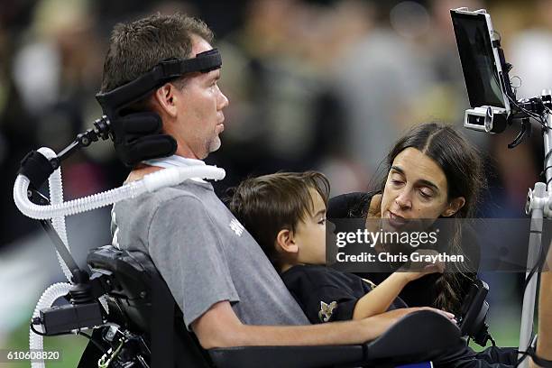 Former New Orleans Saints player Steve Gleason with his wife Michel and son Rivers before the game against the Atlanta Falcons at the Mercedes-Benz...