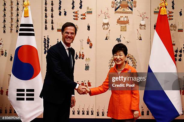 Dutch Prime Minister Mark Rutte shakes hands with South Korea's President Park Geun-Hye prior their meeting at the Presidential blue house on...