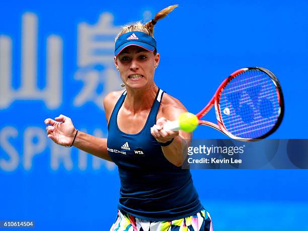 Angelique Kerber of Germany returns a shot to Kristina Mladenovic of France during their third round match on Day three of the 2016 Dongfeng Motor...
