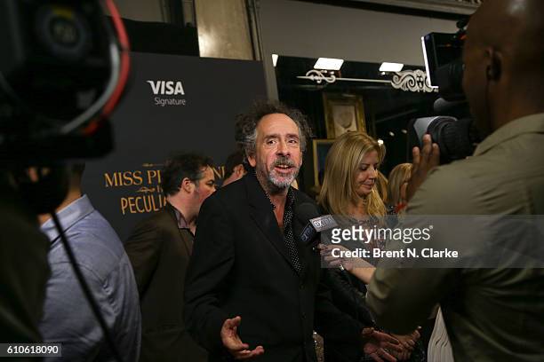 Director Tim Burton speaks to a reporter during the "Miss Peregrine's Home for Peculiar Children" New York premiere held at Saks Fifth Avenue on...