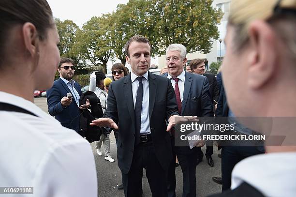 Former French Economy Minister and founder of the political movement "En Marche" Emmanuel Macron speaks with students of the cooking school "Cuisine...