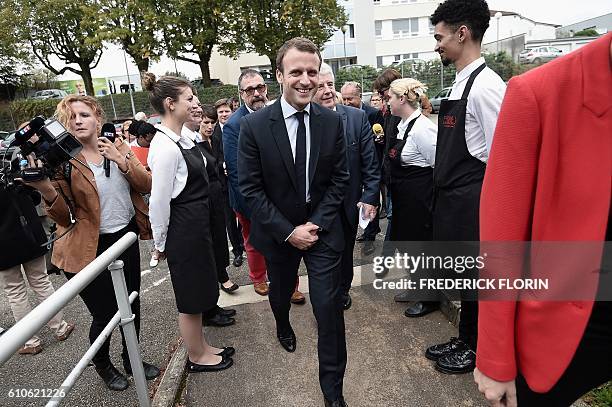 Former French Economy Minister and founder of the political movement "En Marche" Emmanuel Macron arrives to visit the cooking school "Cuisine mode...