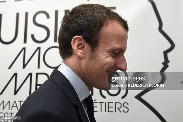 Former French Economy Minister and founder of the political movement "En Marche" Emmanuel Macron visits the cooking school "Cuisine mode d'emploi"...