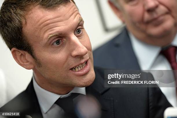 Former French Economy Minister and founder of the political movement "En Marche" Emmanuel Macron addresses the media during a visit to the cooking...