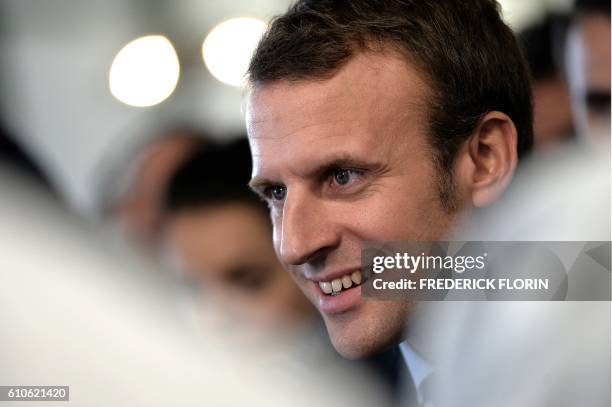 Former French Economy Minister and founder of the political movement "En Marche" Emmanuel Macron addresses the media during a visit to the cooking...