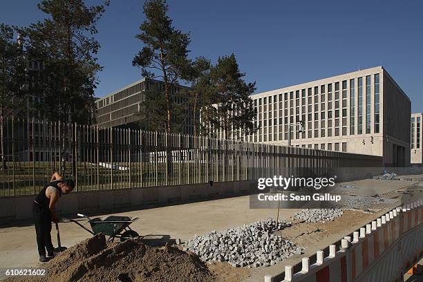 Worker shovels cobblestones outside the construction site of the new headquarters of the German Federal Intelligence Service on September 27, 2016 in...