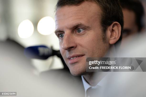 Former French Economy Minister and founder of the political movement "En Marche" Emmanuel Macron addresses the media during a visit at the cooking...
