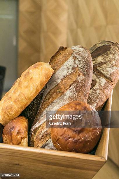 assorted bread loaves in  wooden basket - sweet bread stock pictures, royalty-free photos & images