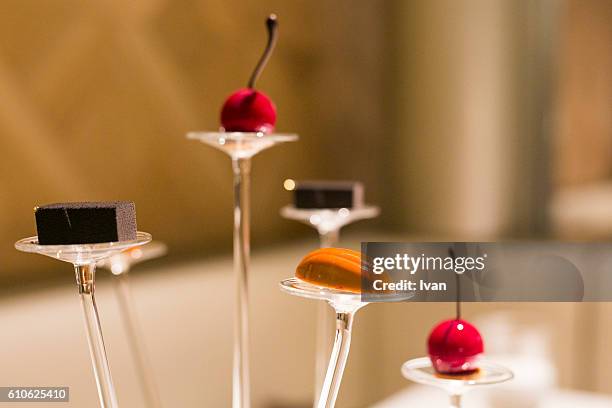 luxury molecular gastronomy dessert, almond caramel chocolate, cherry candy and sesame cookie - dry ice food stock pictures, royalty-free photos & images