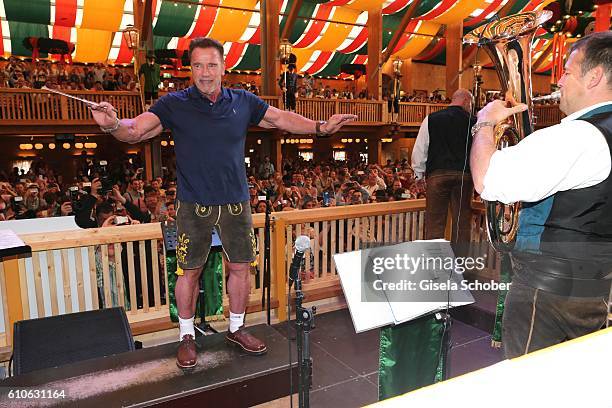 Arnold Schwarzenegger conducts the orchestra at the Schuetzen Festzelt during the Oktoberfest at Theresienwiese on September 27, 2016 in Munich,...