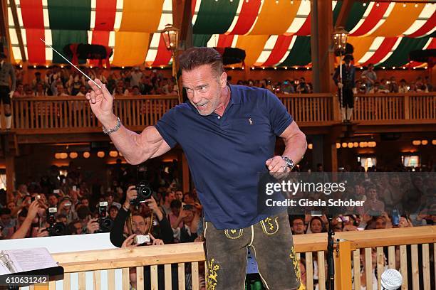 Arnold Schwarzenegger conducts the orchestra at the Schuetzen Festzelt during the Oktoberfest at Theresienwiese on September 27, 2016 in Munich,...