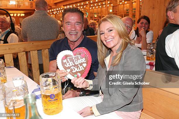 Arnold Schwarzenegger and his girlfriend Heather Milligan visit the Schuetzen Festzelt during the Oktoberfest at Theresienwiese on September 27, 2016...