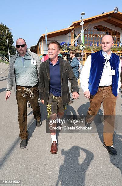 Arnold Schwarzenegger and his bodyguard Fabian Pomplun visit the Schuetzen Festzelt with bodyguards during the Oktoberfest at Theresienwiese on...