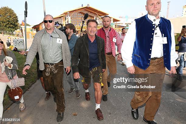 Arnold Schwarzenegger and his bodyguard Fabian Pomplun visit the Schuetzen Festzelt with bodyguards during the Oktoberfest at Theresienwiese on...