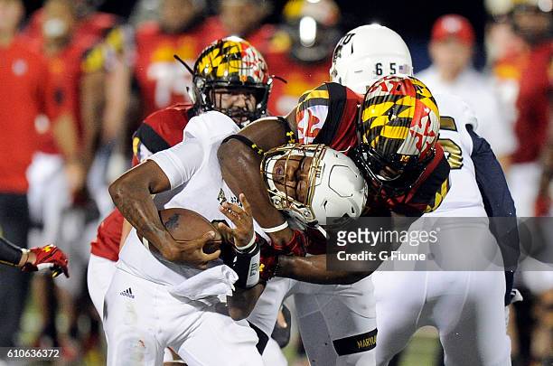 Jesse Aniebonam of the Maryland Terrapins tackles Maurice Alexander of the FIU Panthers at FIU Stadium on September 9, 2016 in Miami, Florida.