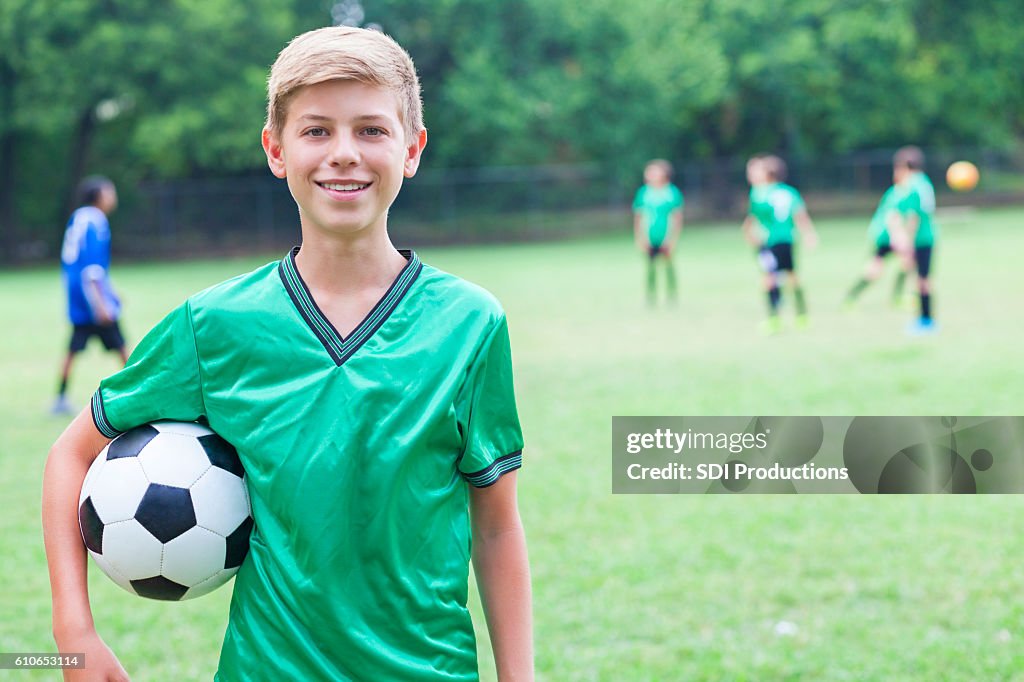 Handsome Caucasian soccer player with ball