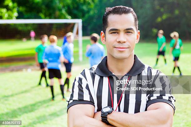 confident athlete referee at soccer game - sports official stockfoto's en -beelden