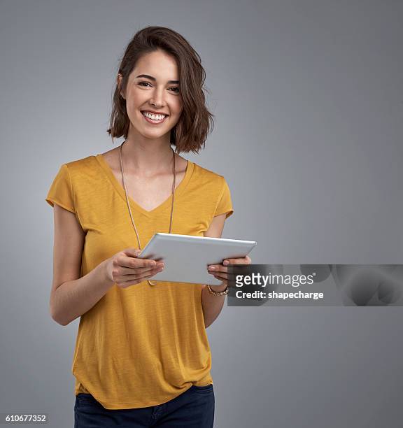 my tablet meets all of my organizational and entertainment needs - woman portrait looking up studio stock pictures, royalty-free photos & images