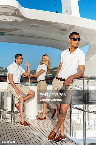 happy crew members on luxury yacht - crew stock pictures, royalty-free photos & images