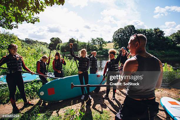 paddleboarding class - youth activities stock pictures, royalty-free photos & images