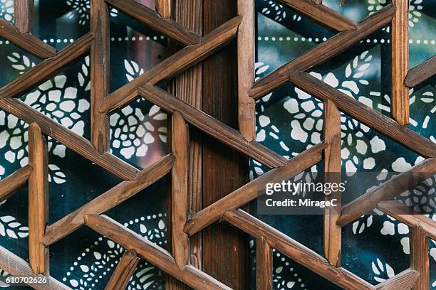 traditional blue and white pattern textile on an old window - chinese window pattern stockfoto's en -beelden