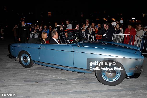 Hugh Grant and his girlfriend Anna Eberstein arrive in an oldtimer at the 'Florence Foster Jenkins' Premiere and Golden Icon award ceremony during...