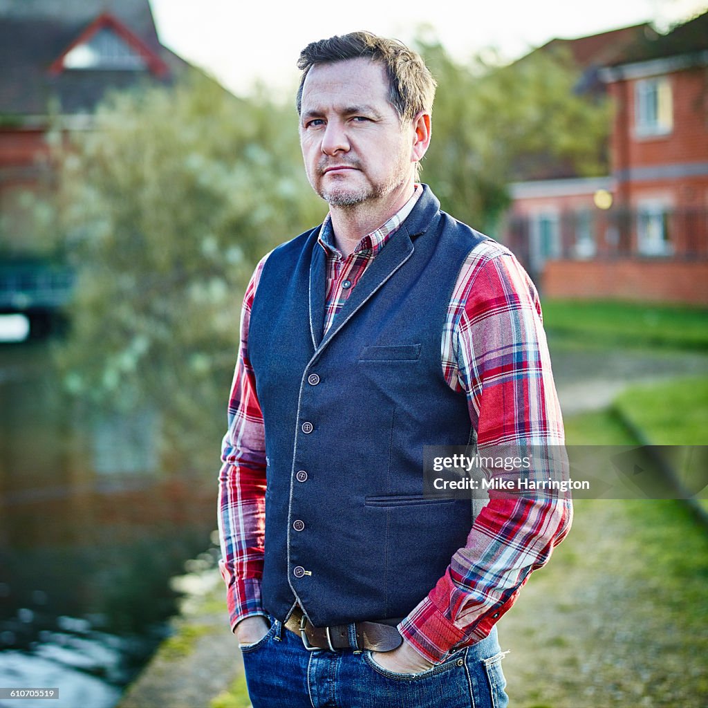 Mature male standing by river