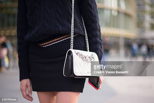 Guest poses with a Miu Miu bag before the Koche show at the Passage de la Canopee during Paris Fashion Week Womenswear SS17 on September 27, 2016 in...