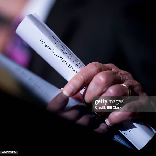 Senate Majority Leader Mitch McConnell, R-Ky., holds a copy of his opening remarks as he speaks to the press about the continuing resolution in the...