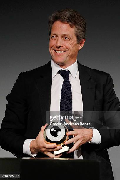 Hugh Grant presents his award at the 'Florence Foster Jenkins' Premiere and Golden Icon award ceremony during the 12th Zurich Film Festival on...