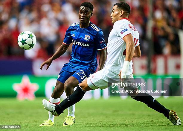 Jordy Gaspar of Olympique Lyonnais competes for the ball with Gabriel Mercado of Sevilla FC during the UEFA Champions League match between Sevilla FC...