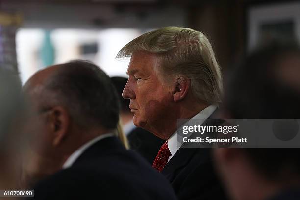 Republican presidential nominee Donald Trump stops by a coffee shop in a Hispanic neighborhood after speaking at a town hall meeting with members of...