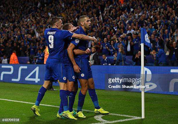 Islam Slimani of Leicester City celebrates with team mates as he scores their first goal during the UEFA Champions League Group G match between...