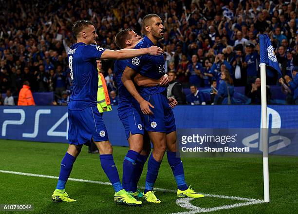 Islam Slimani of Leicester City celebrates with team mates as he scores their first goal during the UEFA Champions League Group G match between...